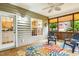 Relaxing screened porch with wood floors, ceiling fan, and view of backyard at 2030 Prairie Ridge Ct, Fuquay Varina, NC 27526