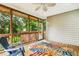Inviting screened porch with ceiling fan, wood flooring, and leafy surroundings at 2030 Prairie Ridge Ct, Fuquay Varina, NC 27526