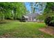Expansive backyard showcasing the home's exterior, patio, screened porch, and lush green lawn at 204 Middlestone Ct, Wake Forest, NC 27587