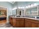 Light-filled bathroom featuring dual vanities, granite countertops, and modern lighting at 204 Middlestone Ct, Wake Forest, NC 27587