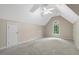 Spacious bonus room with vaulted ceiling, arched window, ceiling fan, and neutral carpet at 204 Middlestone Ct, Wake Forest, NC 27587