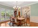 Bright dining room with wainscoting, a large window, and hardwood floors at 204 Middlestone Ct, Wake Forest, NC 27587