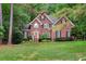 Charming two-story brick home with manicured lawn and lush landscaping at 204 Middlestone Ct, Wake Forest, NC 27587