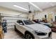 Well-organized garage with ample storage space and a white vehicle parked inside at 204 Middlestone Ct, Wake Forest, NC 27587