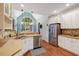 Bright kitchen featuring white cabinets, stainless steel appliances, and a large window offering natural light at 204 Middlestone Ct, Wake Forest, NC 27587