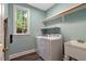 Bright laundry room with washer, dryer, sink and storage at 204 Middlestone Ct, Wake Forest, NC 27587