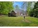 Back of house showing patio area, screened porch and lush landscaping at 204 Middlestone Ct, Wake Forest, NC 27587