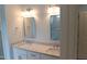 Bathroom featuring double sinks, granite countertops, and decorative mirrors at 2112 Coy St, Burlington, NC 27215