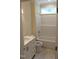 Well-lit bathroom with modern fixtures, tub-shower combo, and single vanity at 2112 Coy St, Burlington, NC 27215