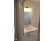 Bathroom featuring a white marble vanity with gold hardware and a frameless mirror at 2112 Coy St, Burlington, NC 27215