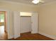 Bedroom featuring hardwood floors, a ceiling fan, and an open closet with rod at 2112 Coy St, Burlington, NC 27215