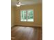 Bedroom featuring hardwood floors, a ceiling fan, and double windows overlooking a yard at 2112 Coy St, Burlington, NC 27215