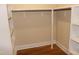 Open walk-in closet with shelves and clothes rods offering customized storage at 2112 Coy St, Burlington, NC 27215
