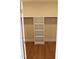 Well-organized walk-in closet with built-in shelving and wood flooring at 2112 Coy St, Burlington, NC 27215