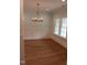 Dining room featuring wood floors, elegant lighting, and wainscoting at 2112 Coy St, Burlington, NC 27215