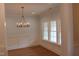 Dining room featuring wood floors, elegant lighting, and wainscoting at 2112 Coy St, Burlington, NC 27215