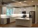 Spacious kitchen featuring white cabinetry, stainless steel appliances, and a large island at 2112 Coy St, Burlington, NC 27215
