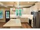 Bright kitchen with an island, stainless steel appliances, and white cabinets at 2112 Coy St, Burlington, NC 27215