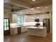 Modern kitchen features white cabinets, stainless appliances, and a center island at 2112 Coy St, Burlington, NC 27215