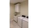 Well-equipped laundry room with modern machines, ample cabinetry, stylish countertops, and flooring at 2112 Coy St, Burlington, NC 27215