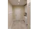 Functional laundry room featuring tile flooring, modern washer and dryer, a utility sink, and storage cabinets at 2112 Coy St, Burlington, NC 27215