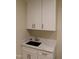 Laundry room includes a utility sink with ample cabinetry, with attractive countertops and modern fixtures at 2112 Coy St, Burlington, NC 27215