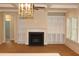 Inviting living room with a fireplace, built-in shelving, coffered ceiling, and lots of natural light at 2112 Coy St, Burlington, NC 27215