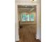 Open living room with hardwood floors, fireplace, and view to the back porch at 2112 Coy St, Burlington, NC 27215