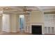 Bright living area featuring built-in shelving surrounding a fireplace, coffered ceiling, and hardwood flooring at 2112 Coy St, Burlington, NC 27215