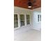 A screened porch with whitewashed brick and ceiling fan offers fresh air and view at 2112 Coy St, Burlington, NC 27215