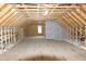 Large unfinished attic space with exposed wood beams and a centrally-placed window at 2112 Coy St, Burlington, NC 27215
