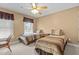 Cozy bedroom with twin beds, ceiling fan, and neutral carpeting at 2503 Saint Pauls Sq, Raleigh, NC 27614