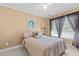 Serene bedroom with neutral decor, ceiling fan, and soft natural lighting at 2503 Saint Pauls Sq, Raleigh, NC 27614