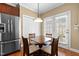 Eat in kitchen breakfast nook with seating for four and stainless refrigerator at 2503 Saint Pauls Sq, Raleigh, NC 27614
