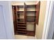 Spacious walk-in closet featuring custom dark wood organizers at 2503 Saint Pauls Sq, Raleigh, NC 27614