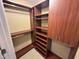 Walk-in closet with custom built-in storage, shelves, and rods at 2503 Saint Pauls Sq, Raleigh, NC 27614