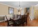 Formal dining room featuring hardwood floors, chandelier, and seating for six at 2503 Saint Pauls Sq, Raleigh, NC 27614