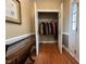 Foyer with an open coat closet filled with coats and jackets with hardwood floors at 2503 Saint Pauls Sq, Raleigh, NC 27614