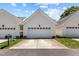 Exterior of a well-maintained garage featuring a white door and paved driveway at 2503 Saint Pauls Sq, Raleigh, NC 27614
