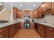 Modern kitchen with stainless steel appliances and wooden cabinetry at 2503 Saint Pauls Sq, Raleigh, NC 27614