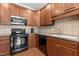 Close up of the kitchen area with a stainless steel microwave and black appliances at 2503 Saint Pauls Sq, Raleigh, NC 27614