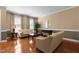 Spacious living room with hardwood floors, neutral paint, large windows, and ample seating at 2503 Saint Pauls Sq, Raleigh, NC 27614