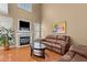 Open living room featuring a fireplace, large windows, and hardwood floors at 2503 Saint Pauls Sq, Raleigh, NC 27614