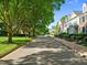 A tree-lined street showcases well-maintained townhomes with manicured lawns in a vibrant neighborhood at 2503 Saint Pauls Sq, Raleigh, NC 27614
