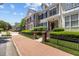 Street view of townhomes with manicured lawns, brick accents, sidewalks and mature trees at 2503 Saint Pauls Sq, Raleigh, NC 27614