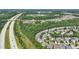 Overhead shot showcasing a community near highways, featuring green spaces and winding streets at 2721 Cameron Pond Dr, Cary, NC 27519