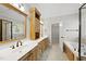 Primary bathroom boasts double sinks, a soaking tub, and a glass enclosed shower at 2721 Cameron Pond Dr, Cary, NC 27519