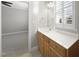 Bright bathroom showcasing a wood vanity, white countertop, and lots of natural light at 2721 Cameron Pond Dr, Cary, NC 27519