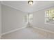 Neutral bedroom featuring carpet, and large windows to provide plenty of natural light at 2721 Cameron Pond Dr, Cary, NC 27519