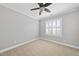 This bedroom features neutral carpeting, a ceiling fan, and white trim at 2721 Cameron Pond Dr, Cary, NC 27519